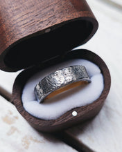 Load image into Gallery viewer, A antique style looking wedding ring that looks like it could have come from centuries ago with its dark grey silver textured finish.