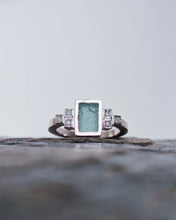 Load image into Gallery viewer, Close up of rare sea glass handcarved into a rectangle and set in 18ct white gold. This engagement ring has an art deco theme and has a total of 6 diamonds flanking the sea glass.
