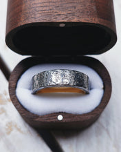 Load image into Gallery viewer, The outside of this wedding ring is dark grey oxidised silver with an 18ct yellow gold inlay. It has a rustic and strong look.