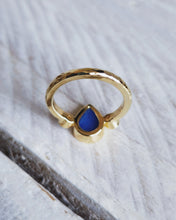 Load image into Gallery viewer, Handcrafted gold engagement ring from the back that shows the blue sea glass and hammered texture on the band, which is inspired by the sea.