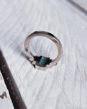 Load image into Gallery viewer, Back view of an 18ct white gold art deco styled engagement ring. It has teal blue rectangle sea glass in the center with 3 square bezels either side that have ocean sourced diamonds within.
