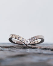 Load image into Gallery viewer, Wedding ring that has a V shaped chevron that is designed to pair with an engagement ring. It has five ocean diamonds that are flush set in the 18ct white gold band with a smooth finish.
