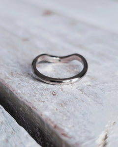 Handmade wedding ring that features sea glass set within the contour, crafted in 18ct gold.