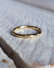 Load image into Gallery viewer, Front view showing the smooth freeform finish on a yellow gold wedding band. It has an organic and rustic look with the subtle curves of the band.
