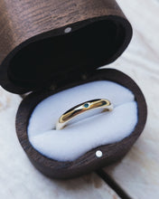 Load image into Gallery viewer, Side view showing the plain wedding ring which is a traditional D shape style. A blueish green piece of sea glass has been set in the 18ct yellow gold band.
