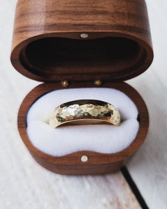 This ring designed for weddings has a D shape band which is traditonal but it has a hammered finish which gives it a rustic yet modern look.