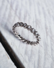 Load image into Gallery viewer, Handcrafted in Cornwall, this wedding band has approximately 20 rock textured bezels the whole way around the band with sparkly ocean diamonds set in each bezel.
