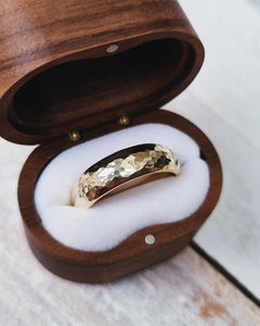 Handcrafted in Cornwall, this wedding ring has a textured finish on it and has been made in yellow gold.