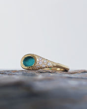 Load image into Gallery viewer, Side view of a TREASURE engagement signet ring showing the scattered ocean diamonds surrounded by sand like grains with east west orientation, raw oval sea glass in the middle.
