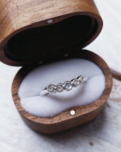 Load image into Gallery viewer, Custom wedding band that is designed to fit with any engagement ring. It has five bezel settings with ocean diamonds and sea glass set within.
