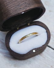 Load image into Gallery viewer, The side angle shows off the rustic texture on this custom wedding ring which is created by hammering the ring with a piece of Cornish reef.
