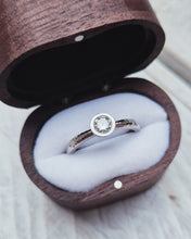 Load image into Gallery viewer, Side view of a bespoke ocean sourced diamond solitaire engagement ring that in inspired by the oceans authentic beauty with its hammered band texture and sparkly diamond.
