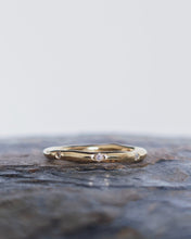Load image into Gallery viewer, Cornish wedding ring that has a curved freeform shaped that is custom made to fit with an engagement ring. It has eight ocean diamonds that are flush set around the organic style band and symbolism the 8 points of a compass.
