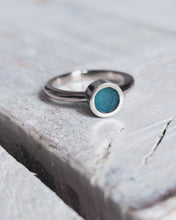 Load image into Gallery viewer, Close up of a bespoke MERMAID engagement ring which features teal sea glass, set within our signature flat topped bezel.
