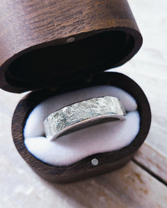 This side view shows the unique hand froged texture that has been created on this mens silver wedding band.