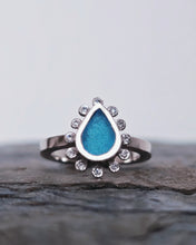 Load image into Gallery viewer, Close-up of our signature handcarved waterdrop sea glass shape in our HALO engagement ring, handcrafted in our Cornish studio.
