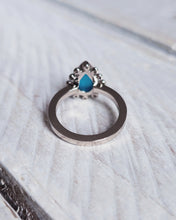 Load image into Gallery viewer, Back view of an 18ct white gold HALO engagement ring with a traditonal smooth finish on the band, just like the ocean&#39;s surface on a calm day.
