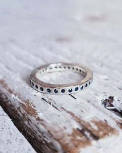 Infinity ocean inspired full eternity ring with flush set sapphires or diamonds and handcrafted in Cornwall.